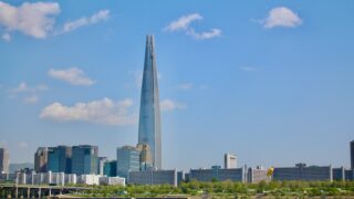 a very tall building towering over a city