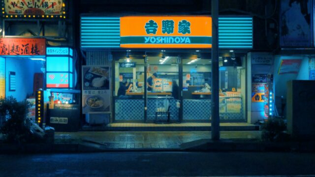 a store front at night with neon lights